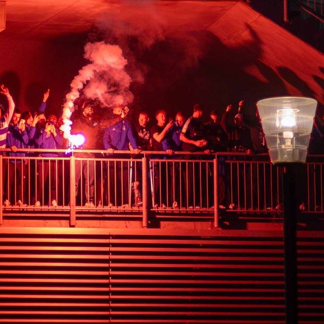 Die Aufstiegsmannschaft feiert mit Pyrotechnik in der Hand den Aufstieg am Stadion.